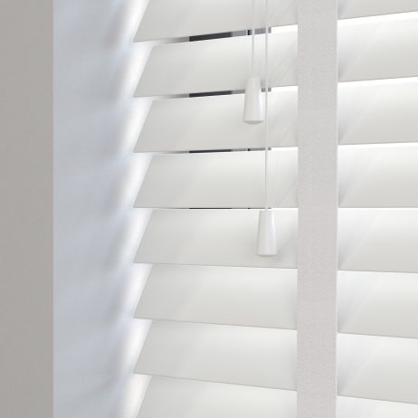 Editions Ultra Pure With Lilly Tape - A front on view of a white wooden venetian blind with the slats in a closed position